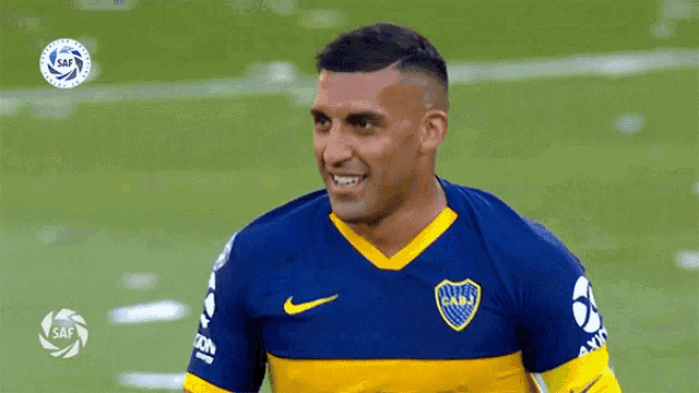 a soccer player wearing a blue and yellow jersey with the letters cabj on it