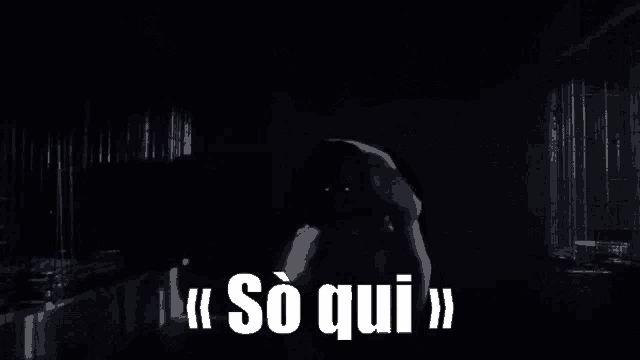 a person in a dark room with the words so qui in white