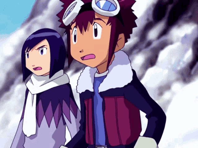 a boy and a girl are standing next to each other and one has goggles on