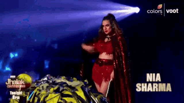 an advertisement for nia sharma shows a woman in a red costume