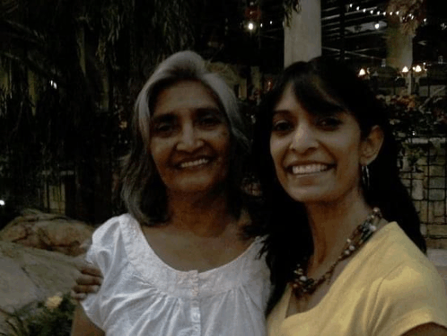 two women are posing for a picture together and smiling for the camera