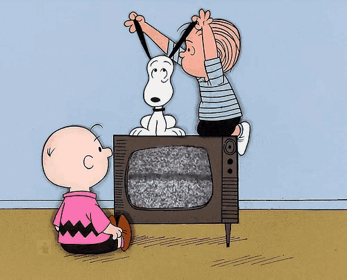 a cartoon of snoopy charlie brown and linus looking at a tv
