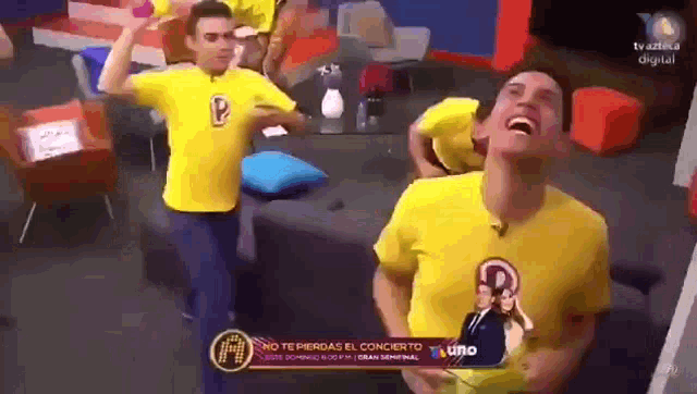a man in a yellow shirt with the letter p on it laughs