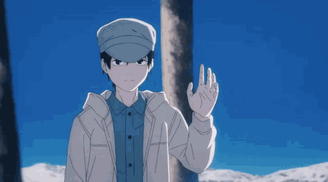 a man in a hat stands in front of a snowy house