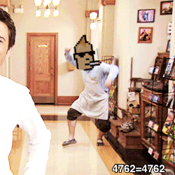 a man standing in a hallway with a pixelated face on his head and the number 4762 on the bottom