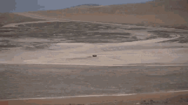 a large explosion is taking place in the middle of a desert