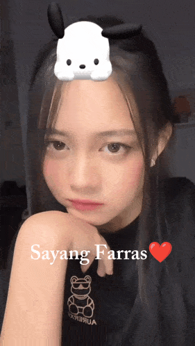 a girl wearing a black shirt with a teddy bear on it and the words sayang farras
