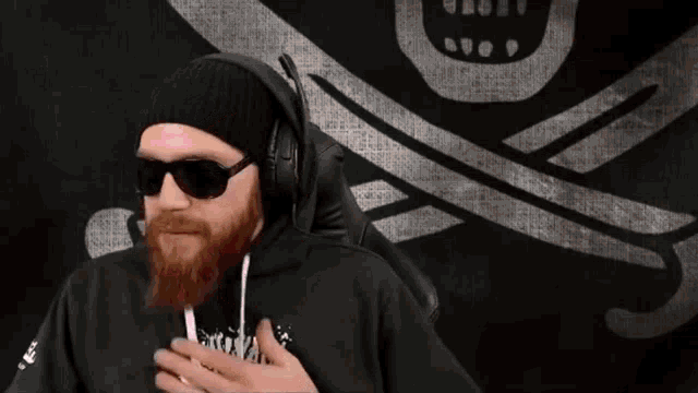 a man with a beard wearing headphones and sunglasses