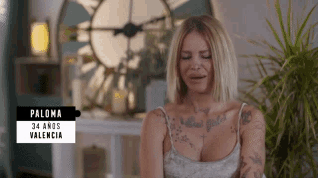 a woman with tattoos and the name paloma on her chest