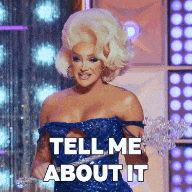 a drag queen in a blue dress holds a trophy and says " tell me about it "