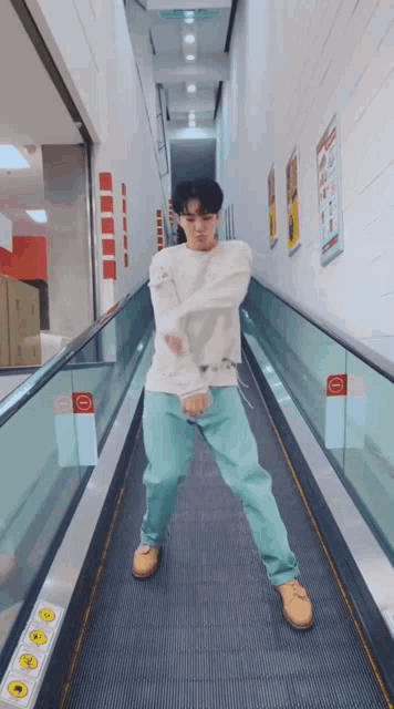 a man is dancing on an escalator with a sign that says ' no entry ' on it