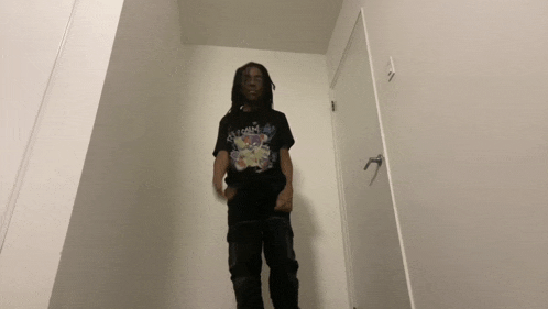 a man wearing a black t-shirt that says ' ice cream ' on it
