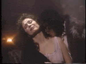 a woman is laying on top of a man in a car .