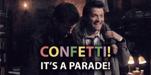 two men are standing next to each other in a dark room with the words confetti it 's a parade .