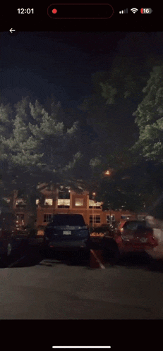 a phone screen shows a blurred image of a person running in a parking lot