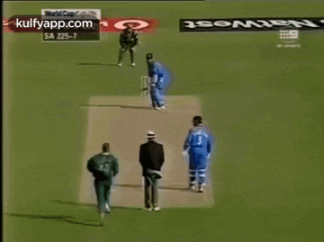 a cricket game is being played on a field with advertisements for kulfyapp.com