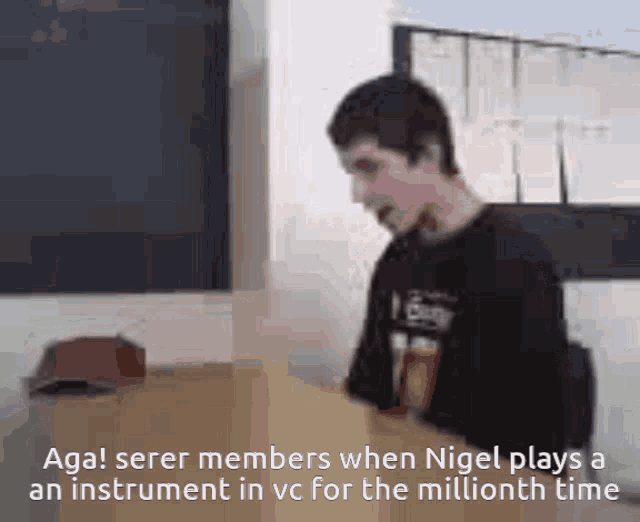 a man sitting at a desk with the words aga serem members when nigel plays a instrument in vc for the millionth time