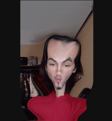 a man with a very large head and a red shirt