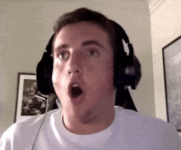 a man wearing headphones is making a surprised face while looking at the camera .