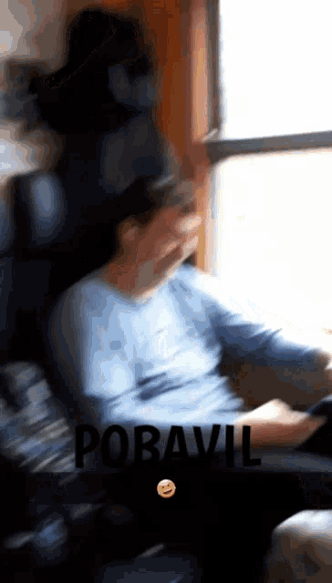 a blurry picture of a person with the word pobavil on the bottom left