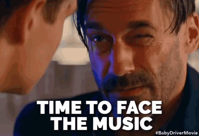 a close up of a man 's face with the words time to face the music above him