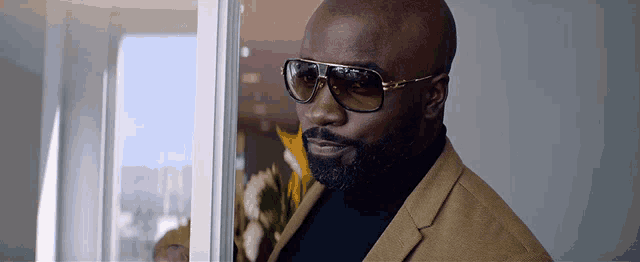 a bald man with a beard wearing sunglasses