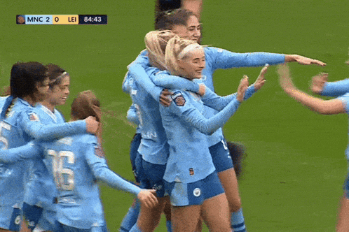a group of female soccer players are hugging and celebrating a goal during a game between lei and mnc