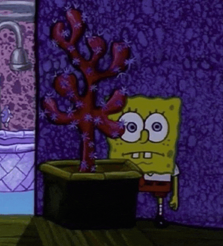 spongebob squarepants is standing next to a potted plant in a room .