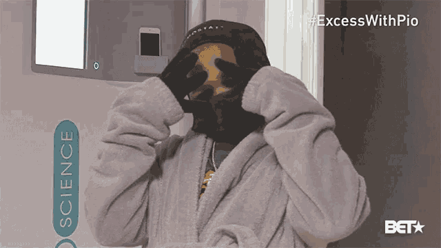 a person covering their face with their hands in front of a sign that says " science "