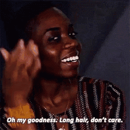 a woman is smiling and talking about her long hair .