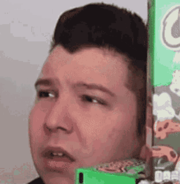 a man is standing next to a box of cereal .