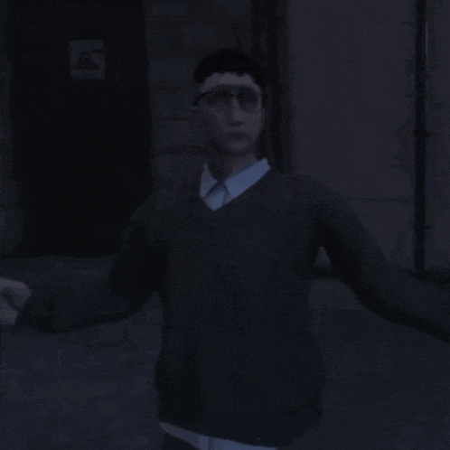 a man wearing glasses and a sweater is standing in front of a building