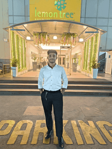 a man is standing in front of a lemon tree restaurant