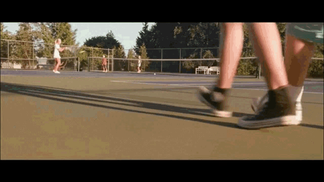 a couple of people playing tennis on a court