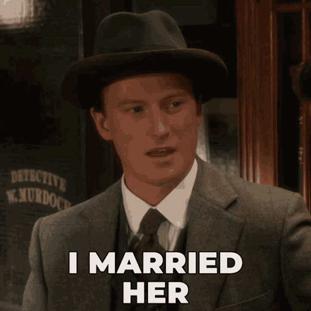 a man in a suit and hat with the words i married her below him