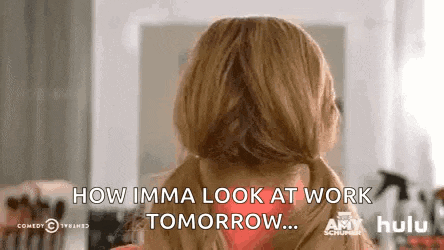 a woman with pigtails is looking at herself in a mirror and says `` how imma look at work tomorrow ... ''