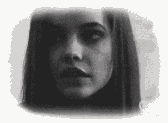 a woman 's face is shown in a black and white photo .