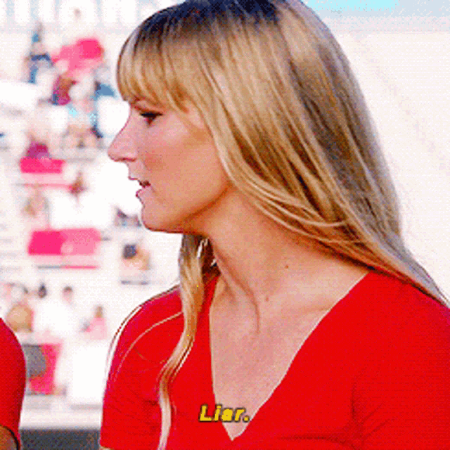 a woman in a red shirt with the word liar written on her chest