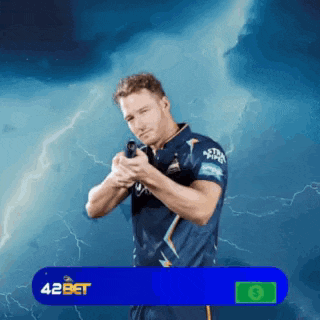 a man in a blue shirt is holding a gun in front of lightning