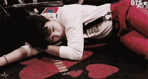 a person laying on the floor with the word bts visible