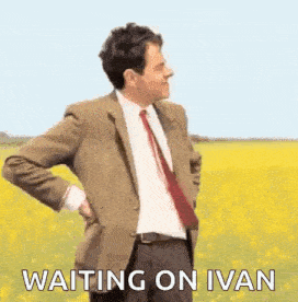 mr bean is standing in a field with his hands on his hips .