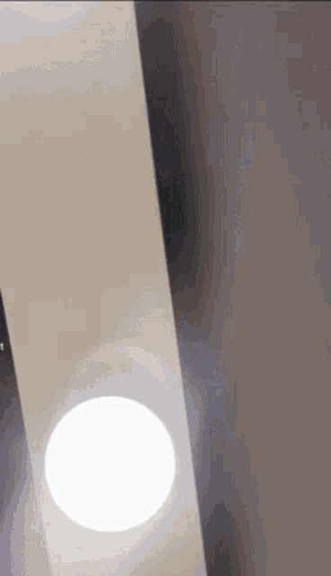 a white light is shining on a white wall .