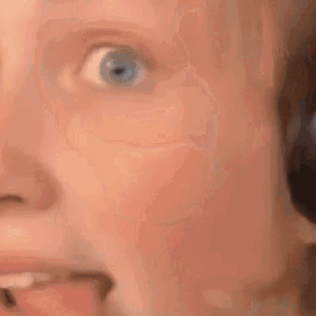 a close up of a person 's face wearing headphones and a microphone .