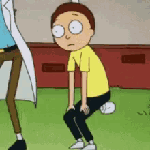 a cartoon character is squatting down on the grass .