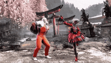 a man and a woman are fighting in a video game in front of a torii gate .