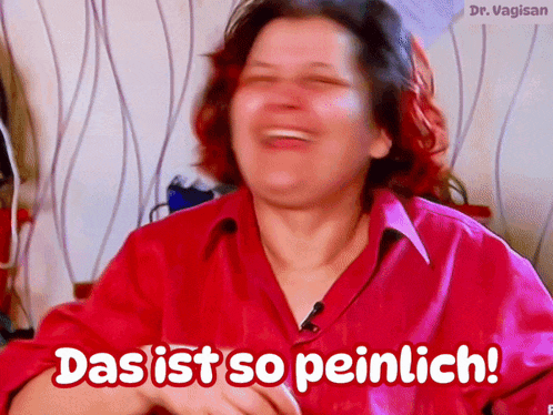 a woman in a red shirt is laughing with das ist so peinlich