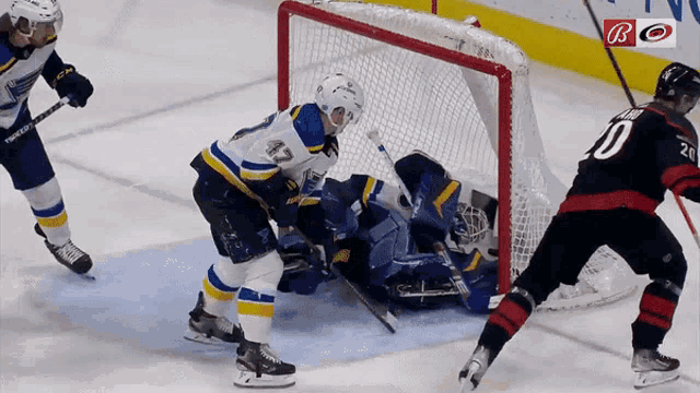a hockey game is being played and the goalie is wearing the number 0
