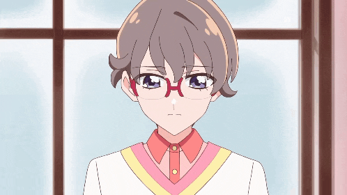 a girl wearing glasses and a pink shirt is looking at the camera