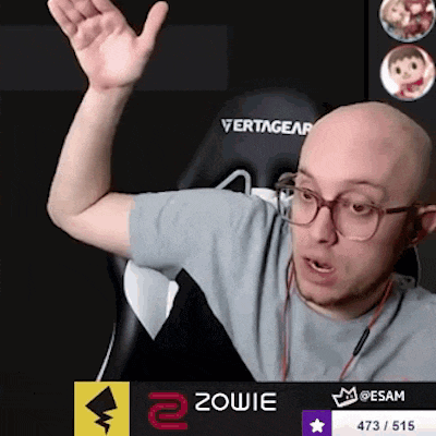 a bald man wearing glasses and ear buds is sitting in a vertagear chair