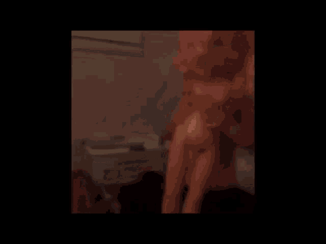 a blurry picture of a person standing in a room with a window .